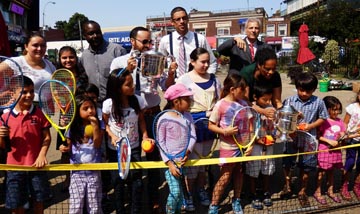 Politicians and kids had the opportunity to play tennis at Corona Plaza. 