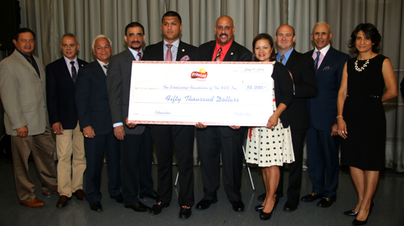 Executives from Frito Lay gave a check of $50,000 to David Corona, president of the National Supermarket Association. 