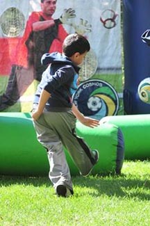 Kicking a soccer ball through the New York Cosmos’ inflatable obstacle course.
