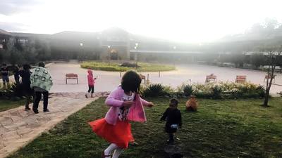 Niños corretean por los jardines de Ciudad de Dios.