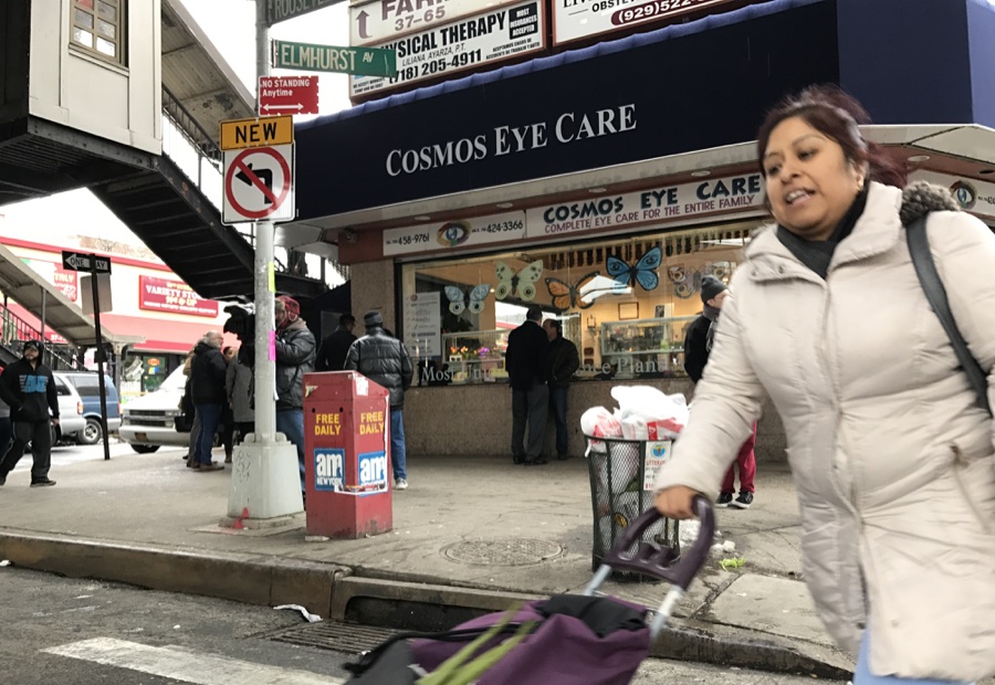 Una madre cruzando la Roosevelt al norte de la calle 90 en Jackson Heights, Queens.