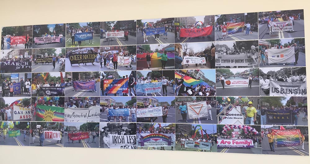 A wal with mane photos of the LGBTQ community.