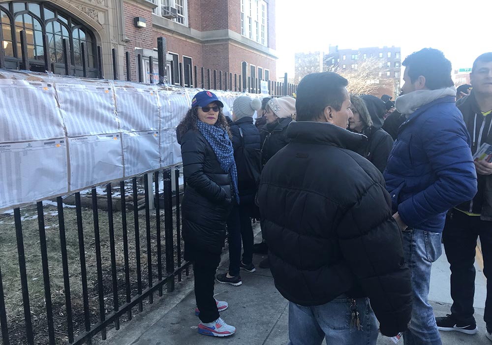 Acot de mala fe: representantes del grupo religioso MIRA haciendo campaña frente a la entrada de la escuela pública de Queens en donde los colombianos acudieron a votar, lo cual es prohibido por ley. Foto Javier Castaño